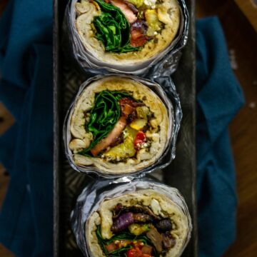 three roasted vegetable wraps in foil