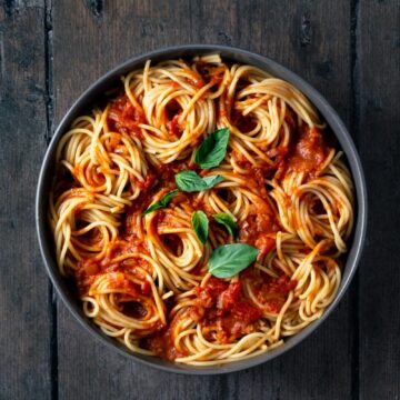 spaghetti and marinara sauce with basil in a bowl