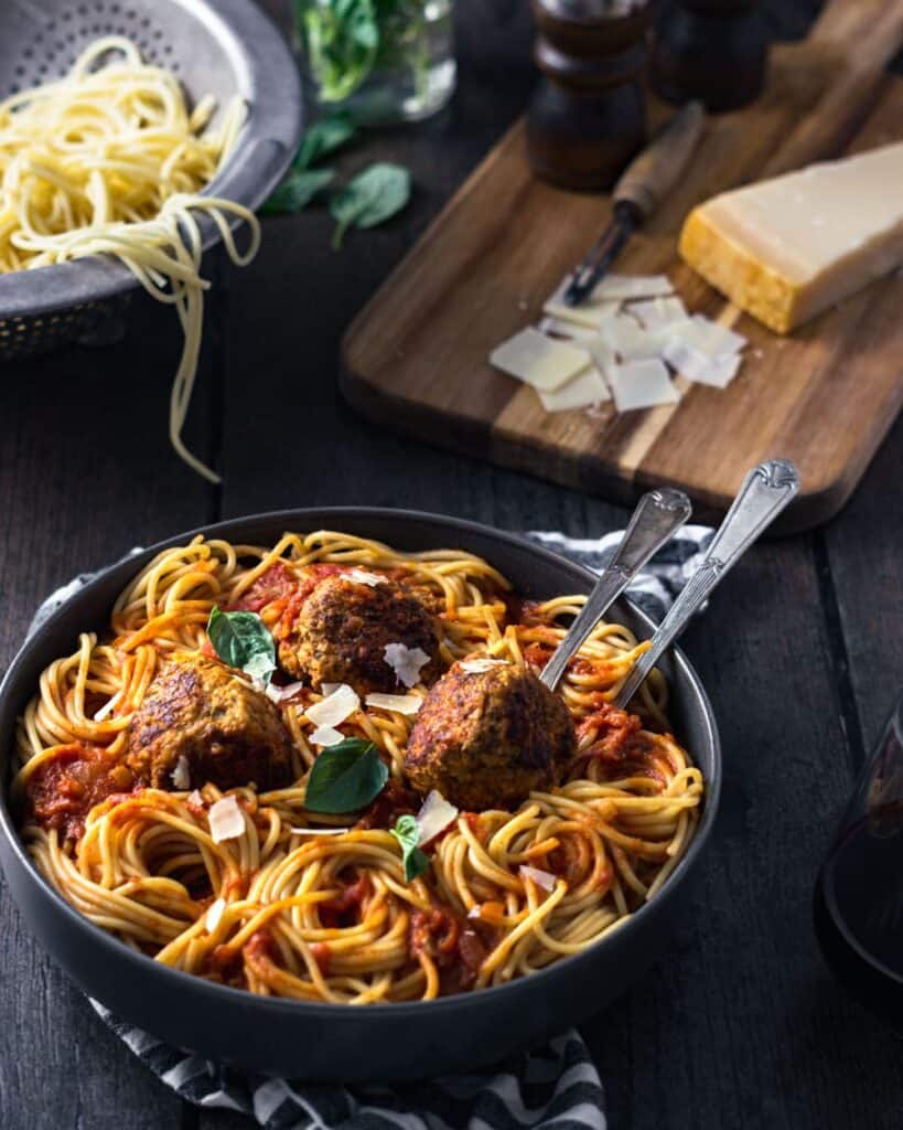 meatballs and spaghetti with marinara and parmesan cheese