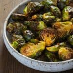 large white bowl with honey sriracha roasted brussels sprouts
