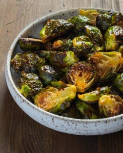 large white bowl with honey sriracha roasted brussels sprouts
