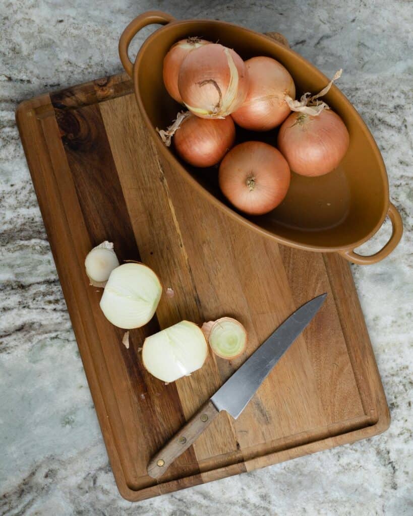 an onion cut in half on a cutting board