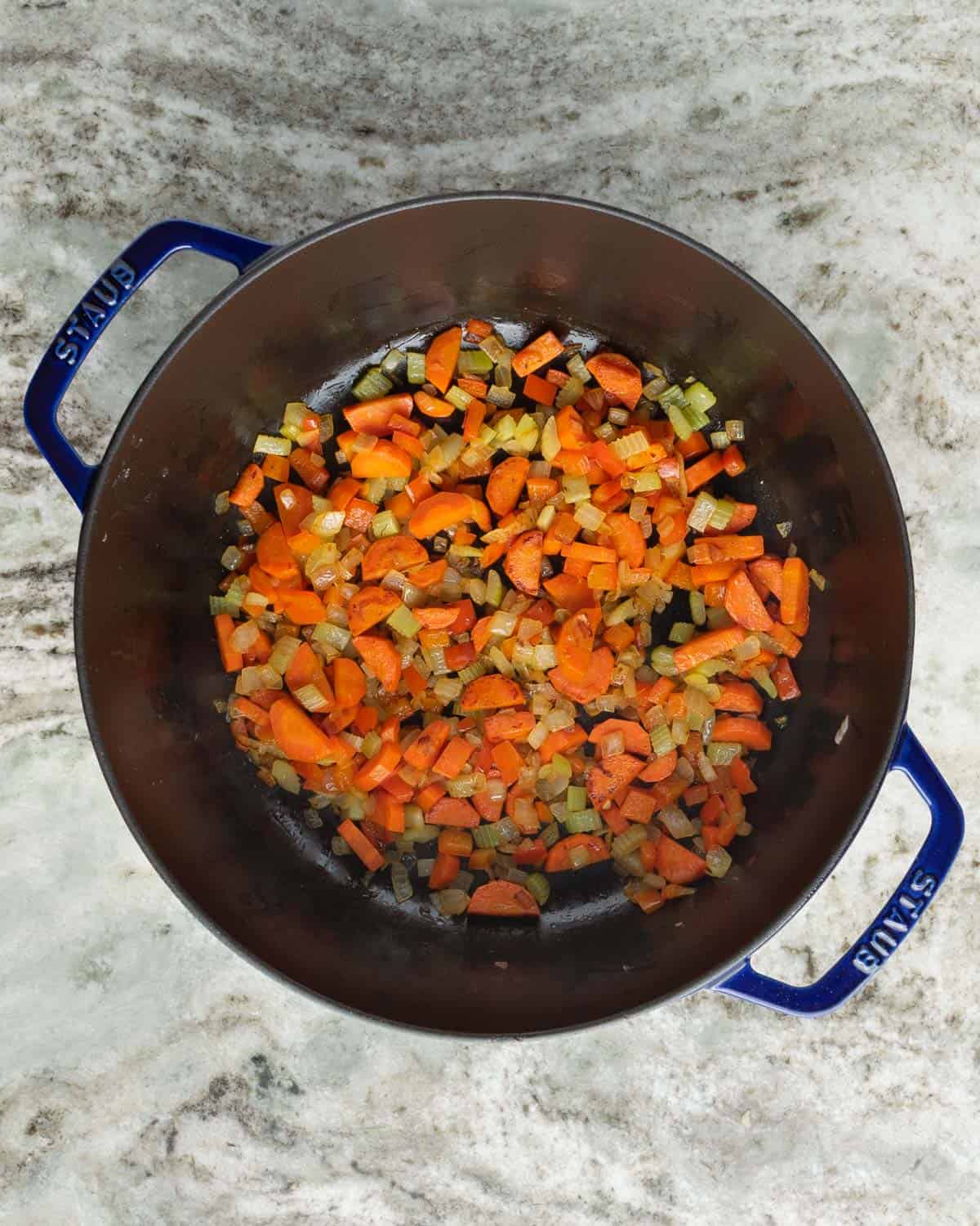 Caramelized vegetables in a large pot.