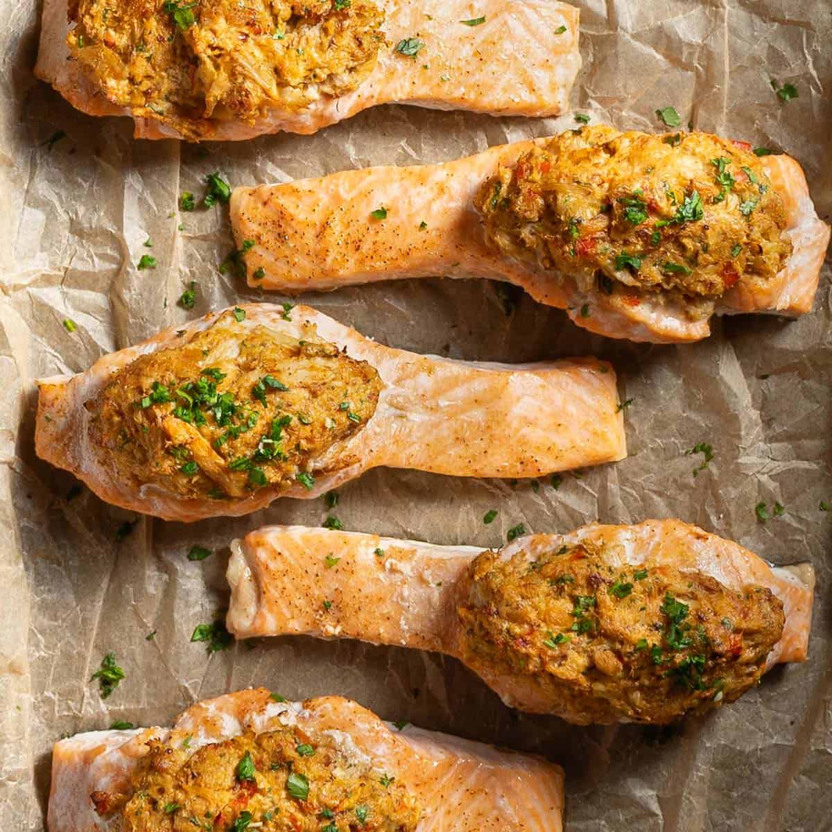 cajun crab stuffed salmon on parchment paper topped with parsley.