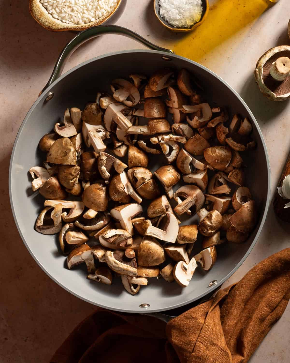 Mushrooms in a skillet before cooking. 