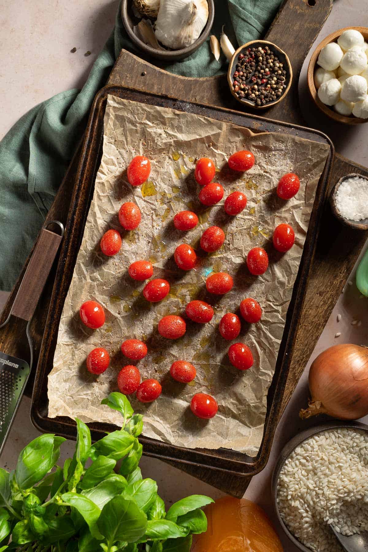 Tomatoes on a baking sheet before roasting.