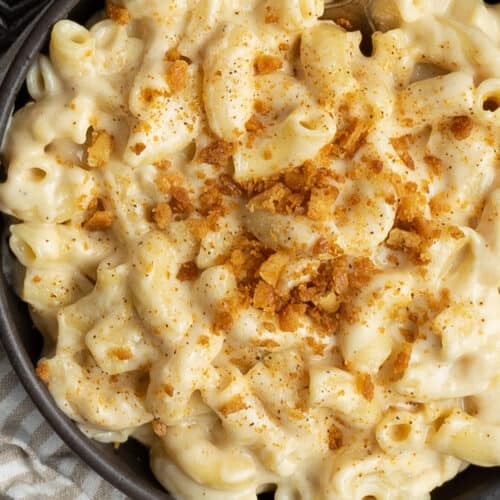 Up close bowl of mac and cheese with buttered cracker crumbs.