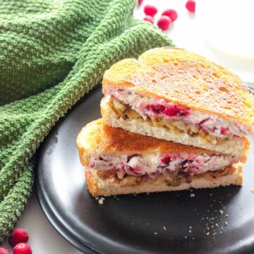 Grilled Turkey Cranberry Cream Cheese Sandwich on a plate with a napkin.