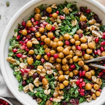 Roasted Chickpea Fall Salad in a bowl with serving spoons.
