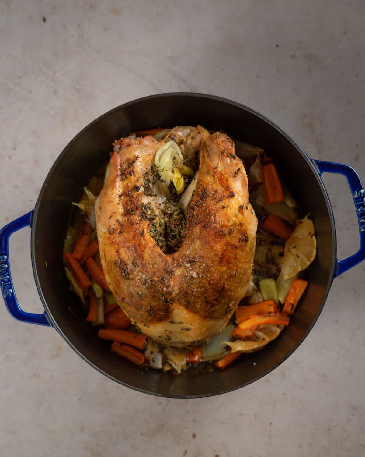 Roasted turkey breast with crispy skin in a dutch oven.