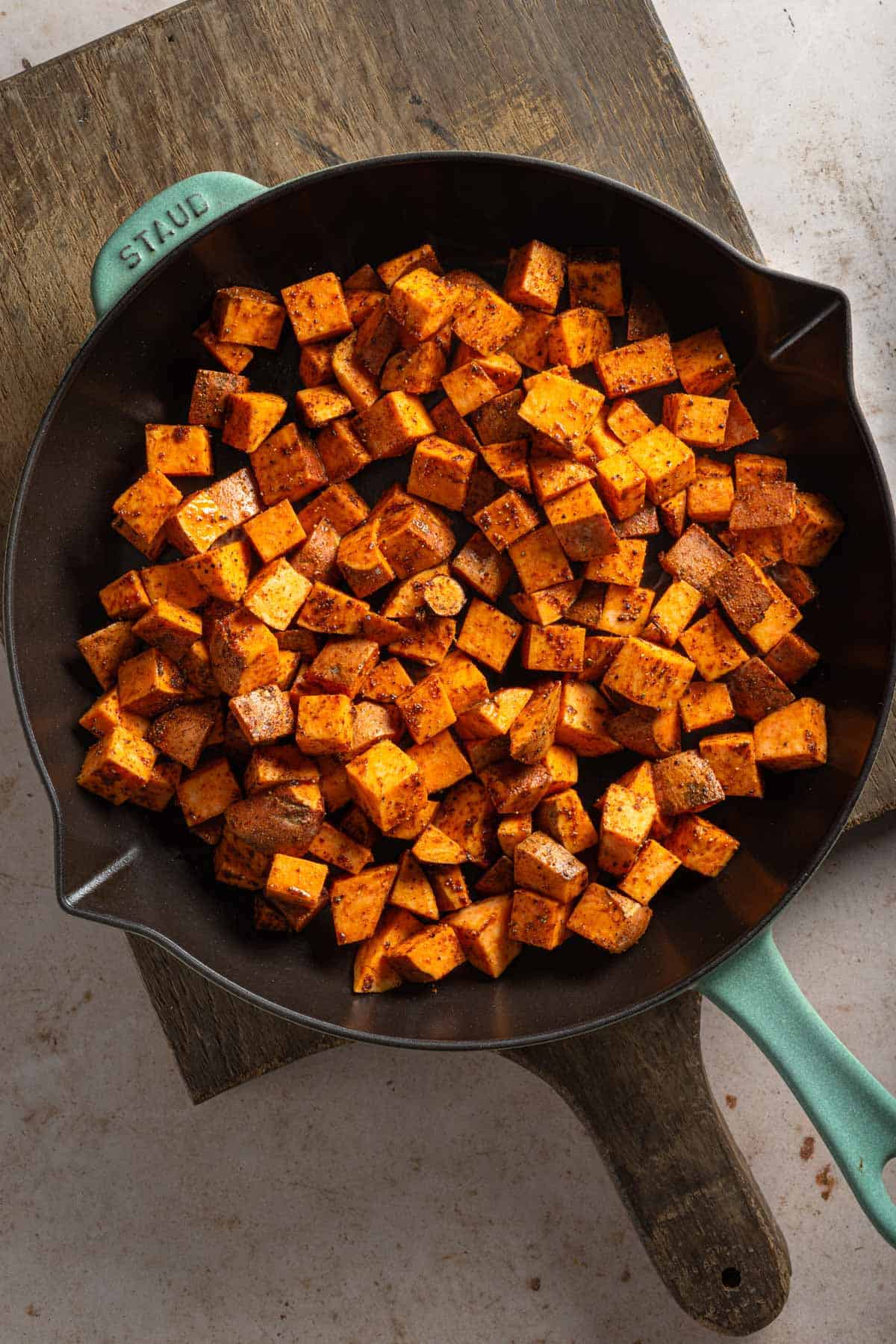 Diced sweet potatoes in a cast iron skillet.