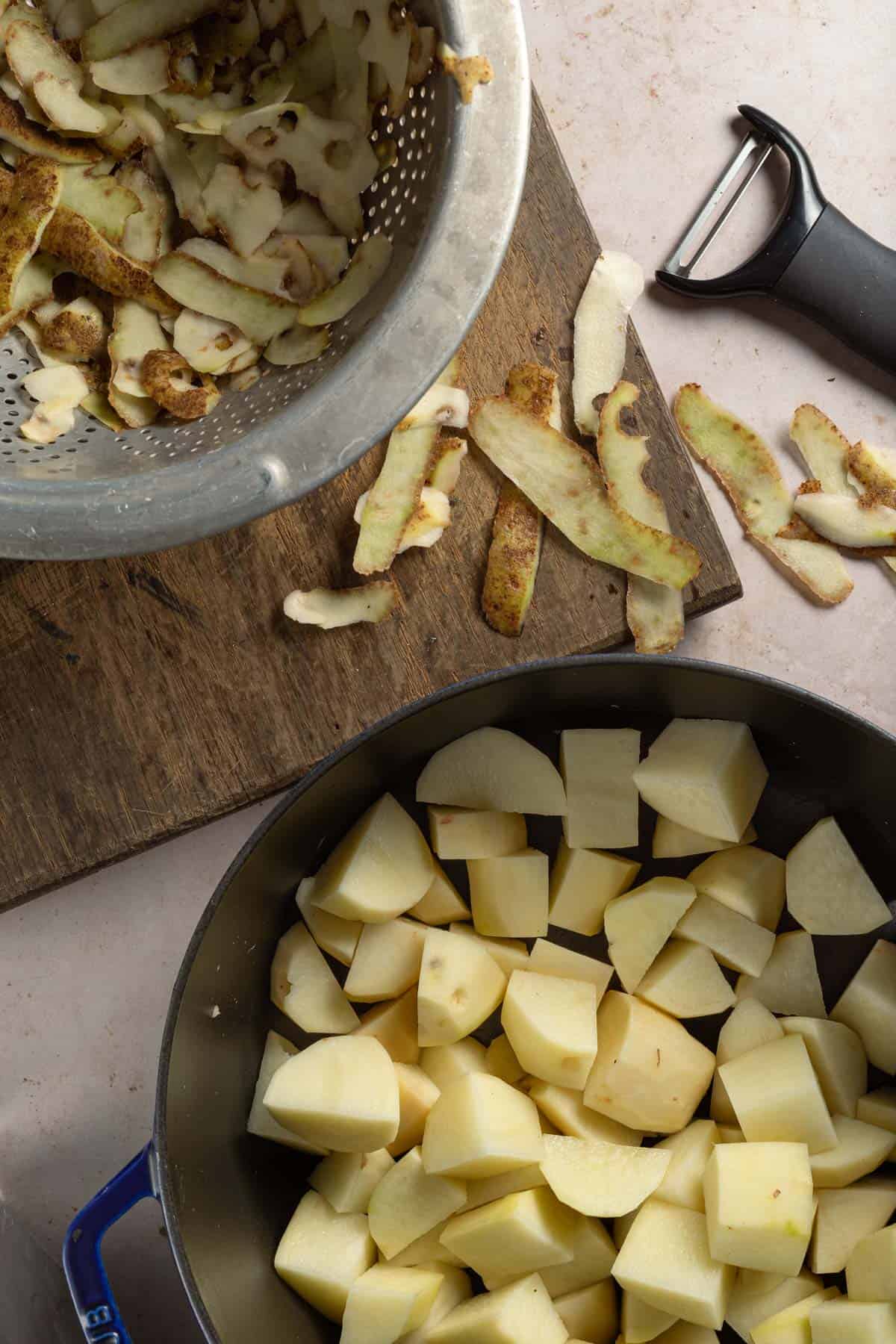 Peeled and diced potatoes in a pot.