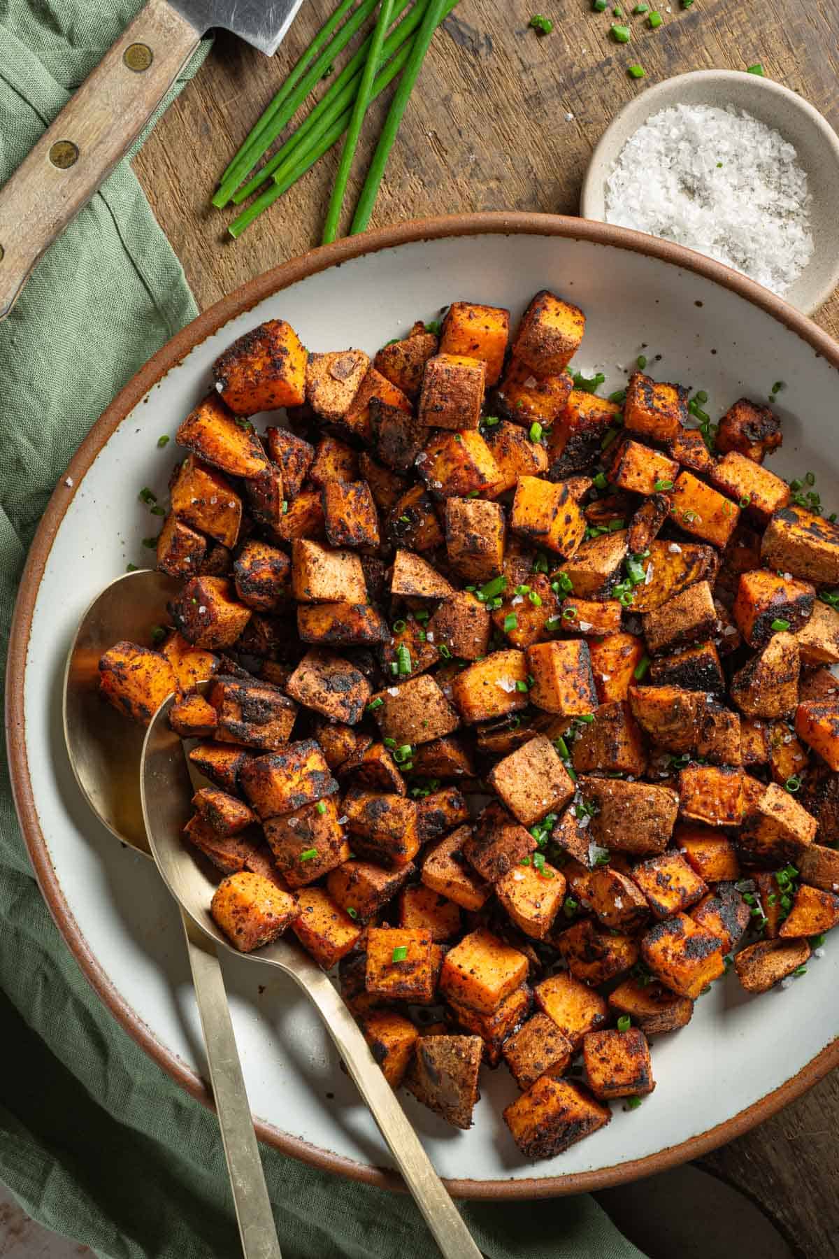 Sautéed Sweet Potatoes in a bowl with chives.