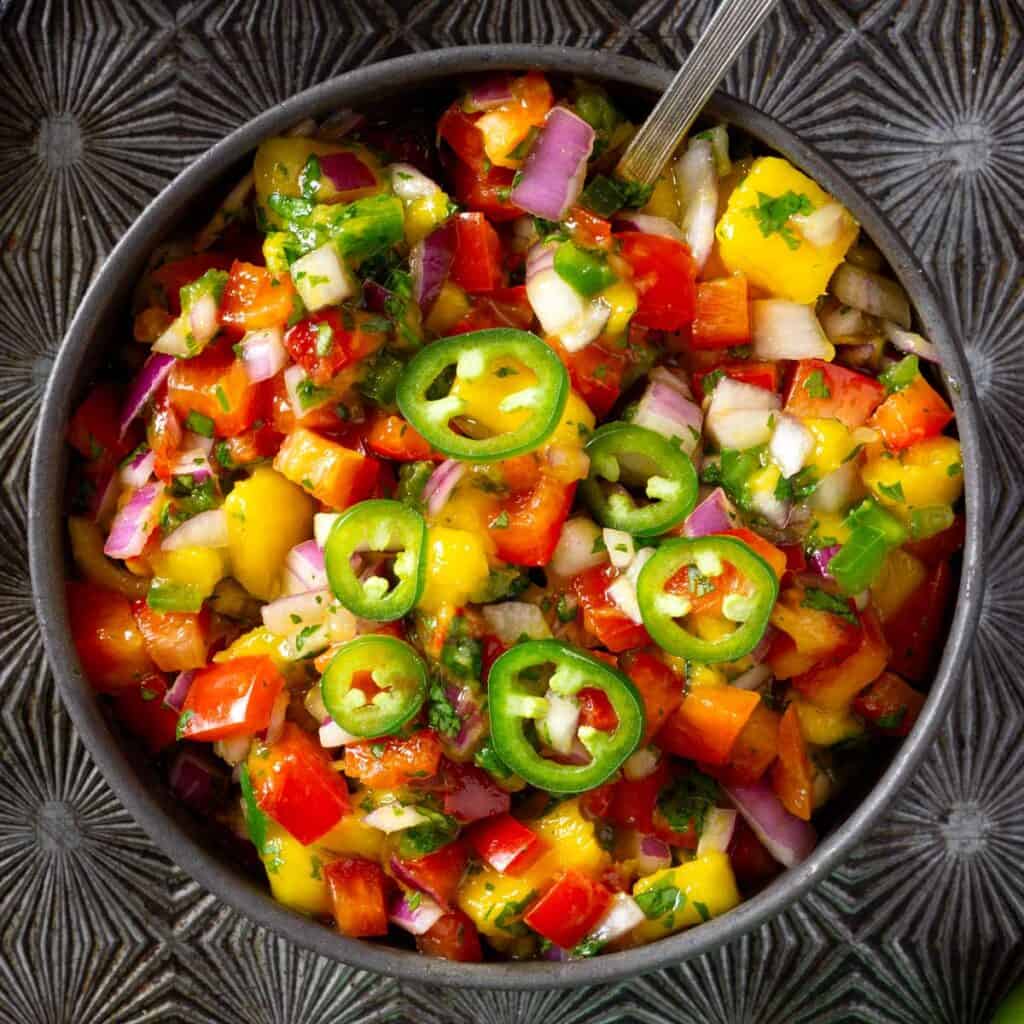 Mango pico de gallo with red peppers, red onion, and jalapeños.
