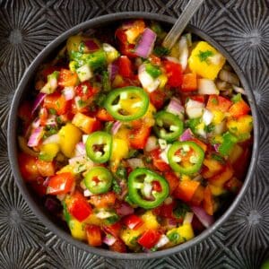 Mango pico de gallo with red peppers, red onion, and jalapeños.