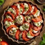 Burrata caprese salad with basil, balsamic glaze, olive oil, and sea salt.