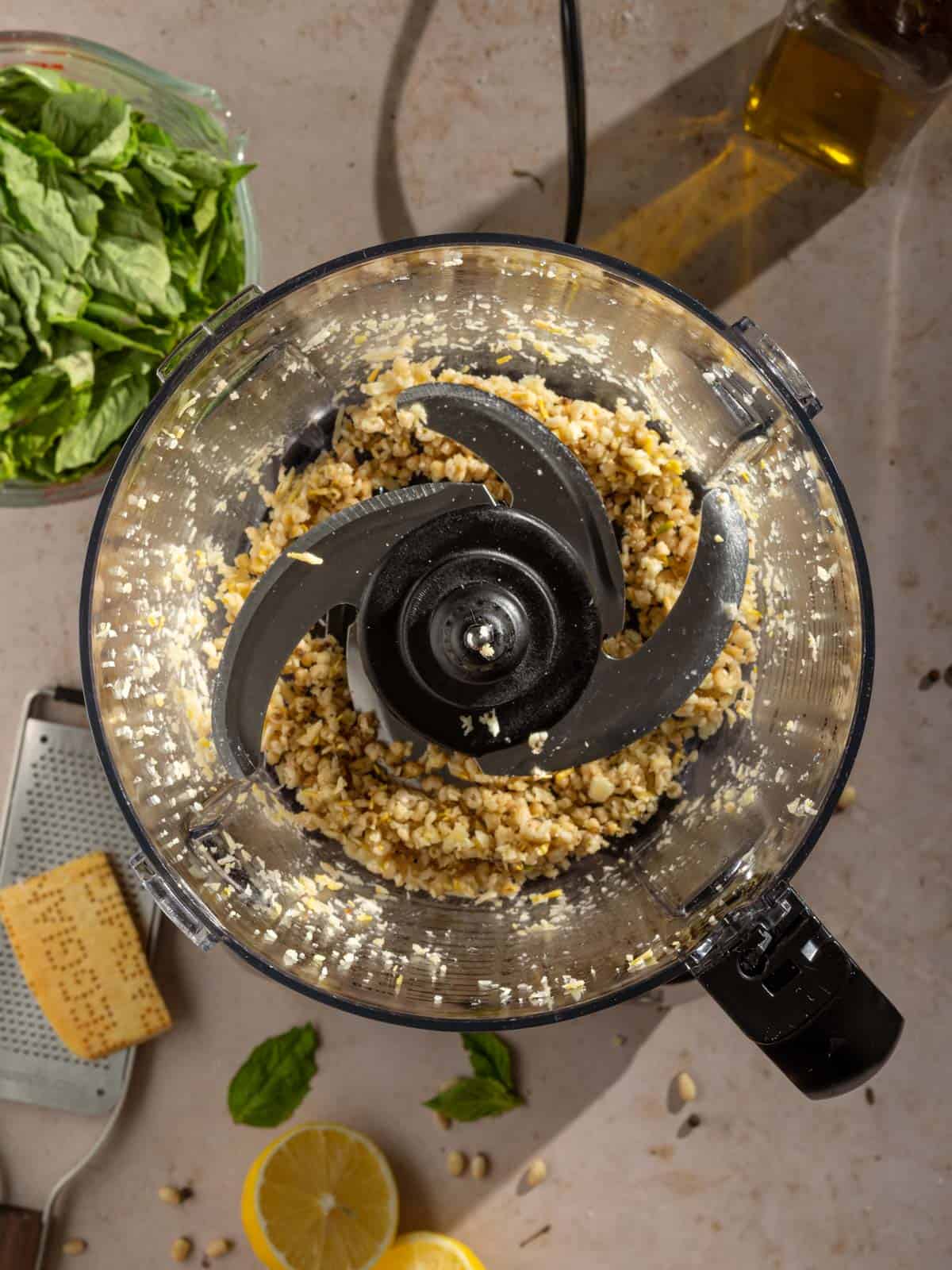 Chopped garlic and pine nuts in a food processor.