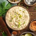 Homemade cajun tartar sauce with dill, cayenne, and green onions.