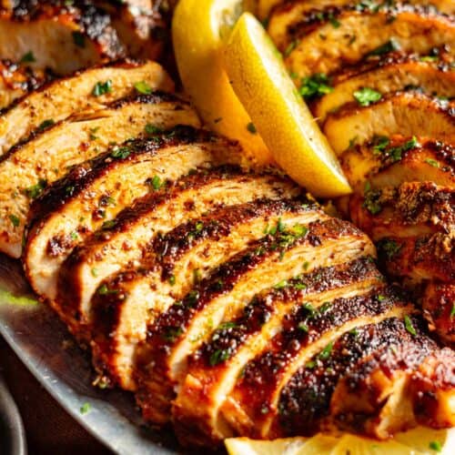 Sliced chicken breasts with lemon.
