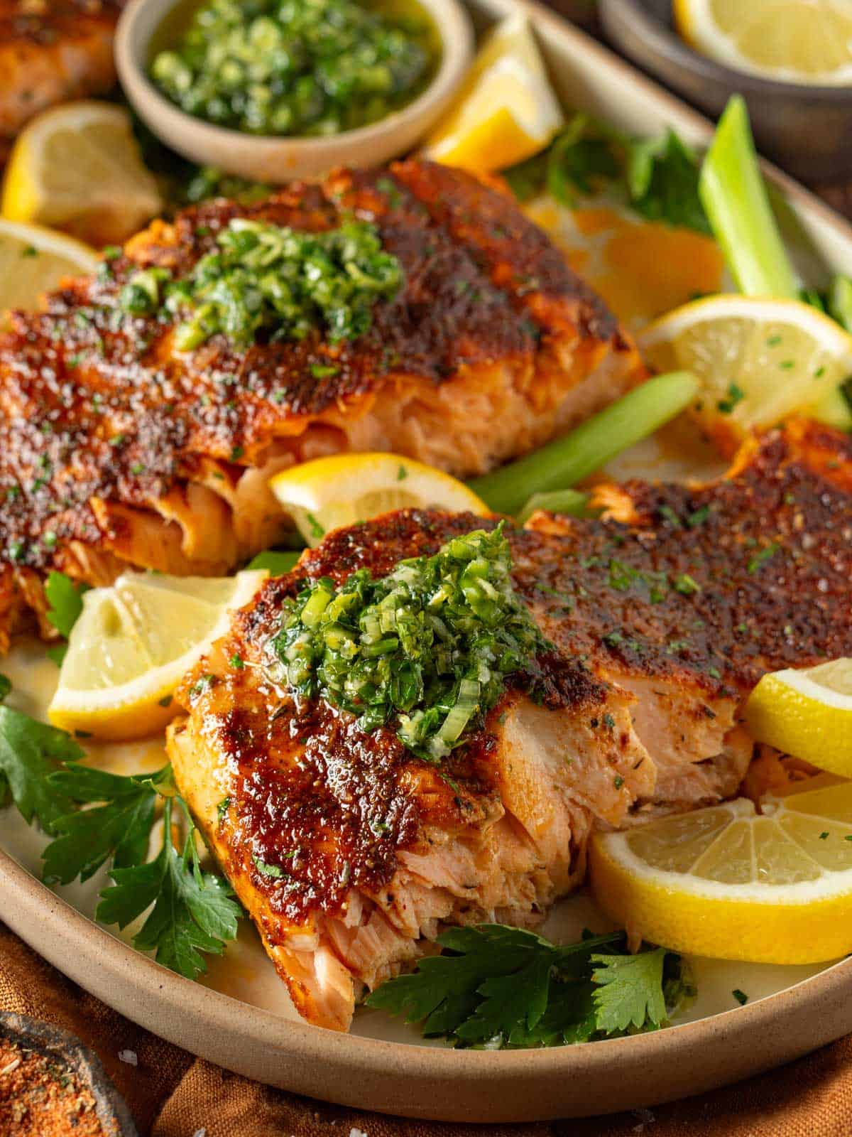 Baked blackened salmon filets with parsley and lemon.