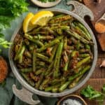 Charred blackened green beans with cajun seasoning in a bowl.