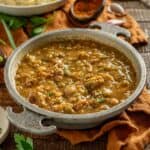 Cajun gravy in a serving bowl with andouille.