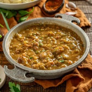 Cajun gravy in a serving bowl with andouille.