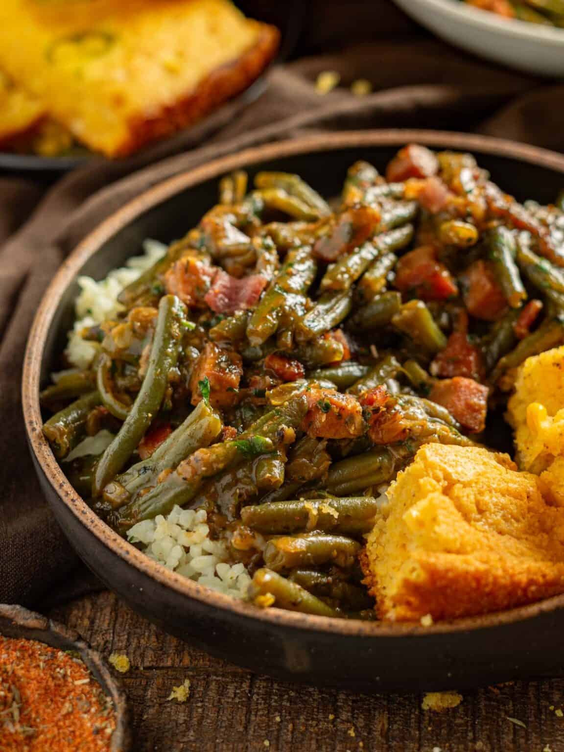 Cajun smothered green beans slow cooked with bacon onion garlic Southern bold flavourful side dish
