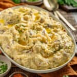 Garlic Red Skin mashed potatoes in a serving plate with butter and chives.