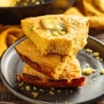A stack of cajun cornbread on a plate.