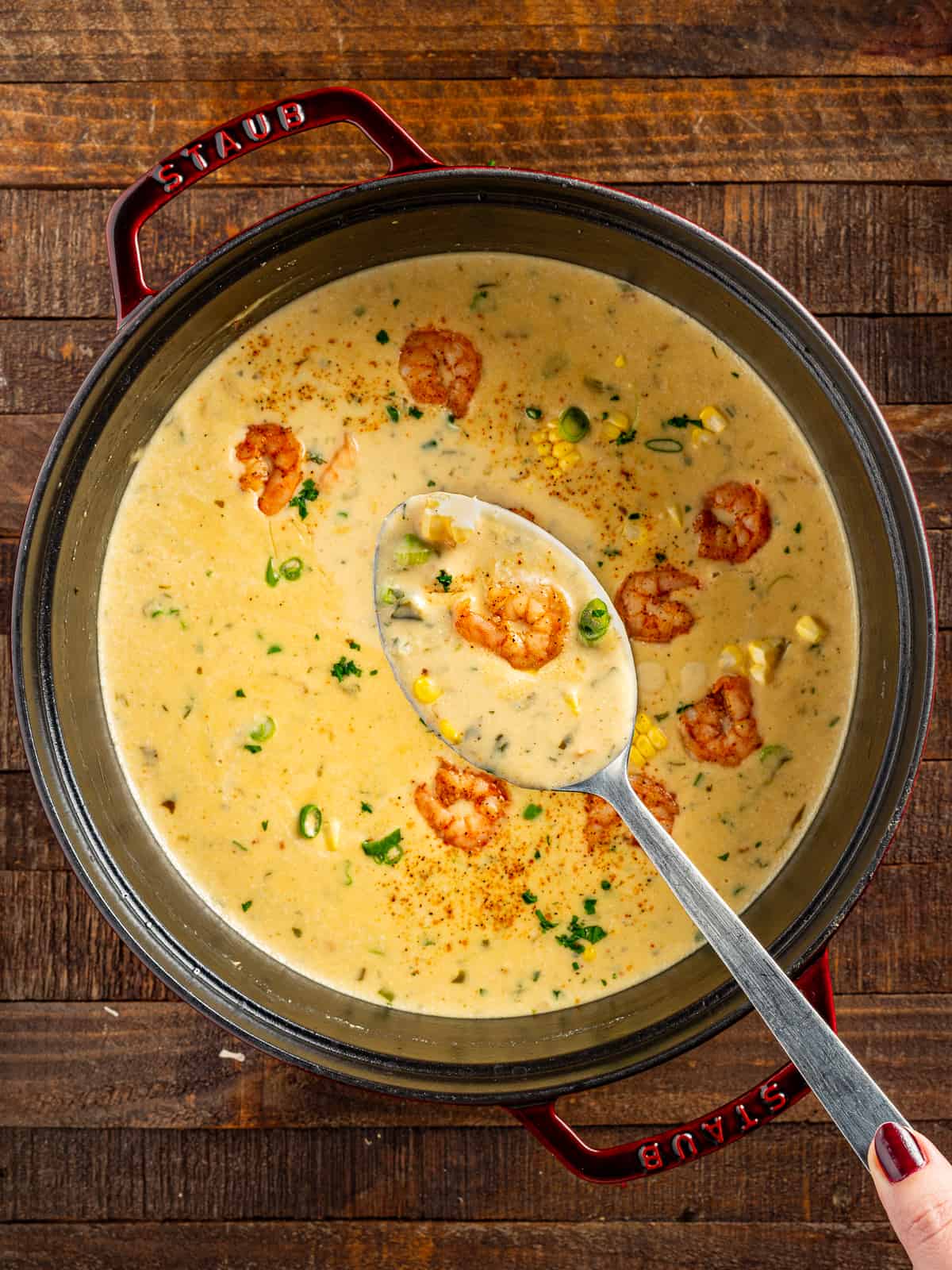 New Orleans shrimp and corn bisque in a pot with a spoon.