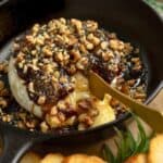 Fig jam baked brie with nuts and rosemary.