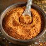 Homemade Creole seasoning in a bowl with a measuring spoon.