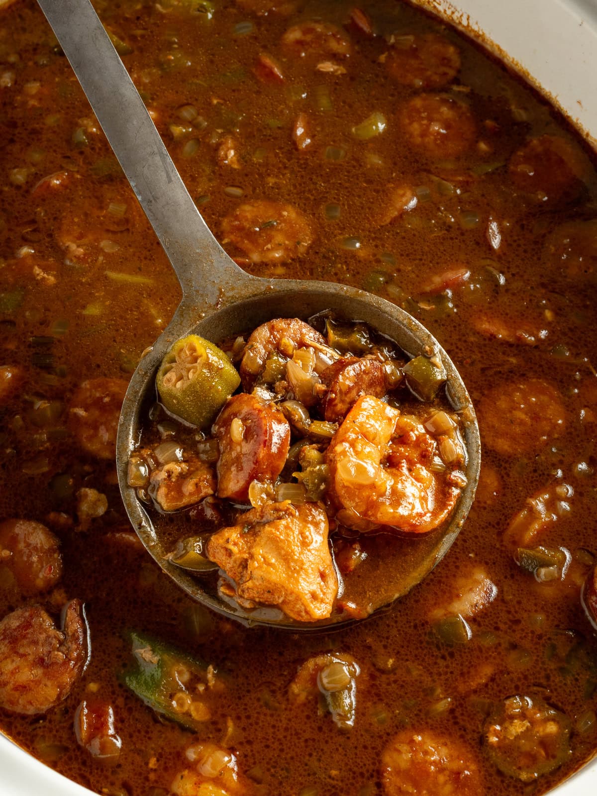 A ladle of slow cooker gumbo.