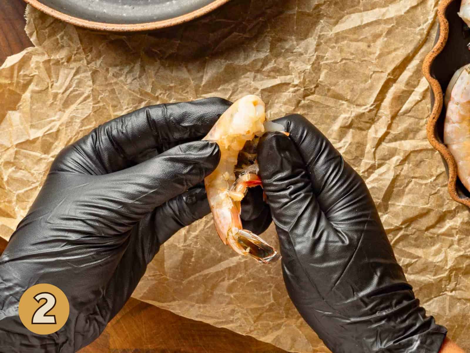 Peeling the legs off a shrimp.