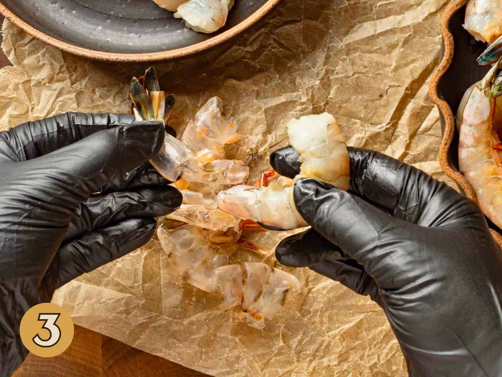 Peeling the tail off a shrimp.