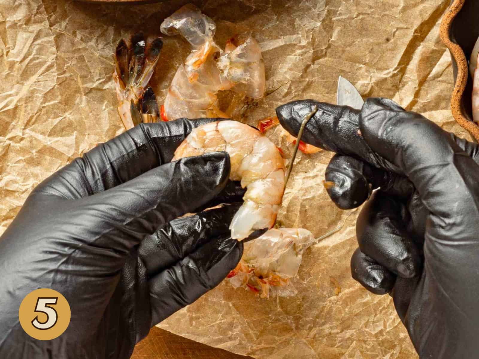 Pulling the vein off a shrimp.