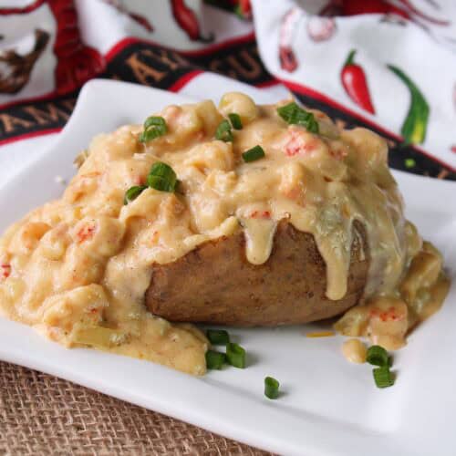 A baked potato with creamy crawfish sauce.