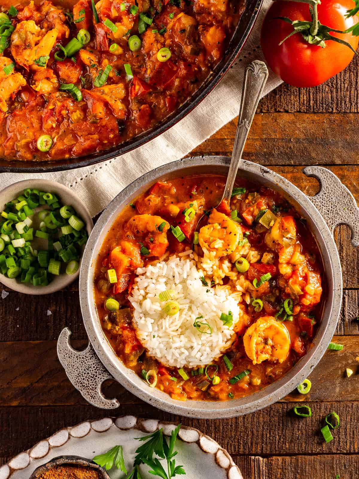 A bowl of authentic shrimp creole with rice and green onions.