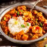 A bowl of authentic New Orleans shrimp creole topped with green onions.