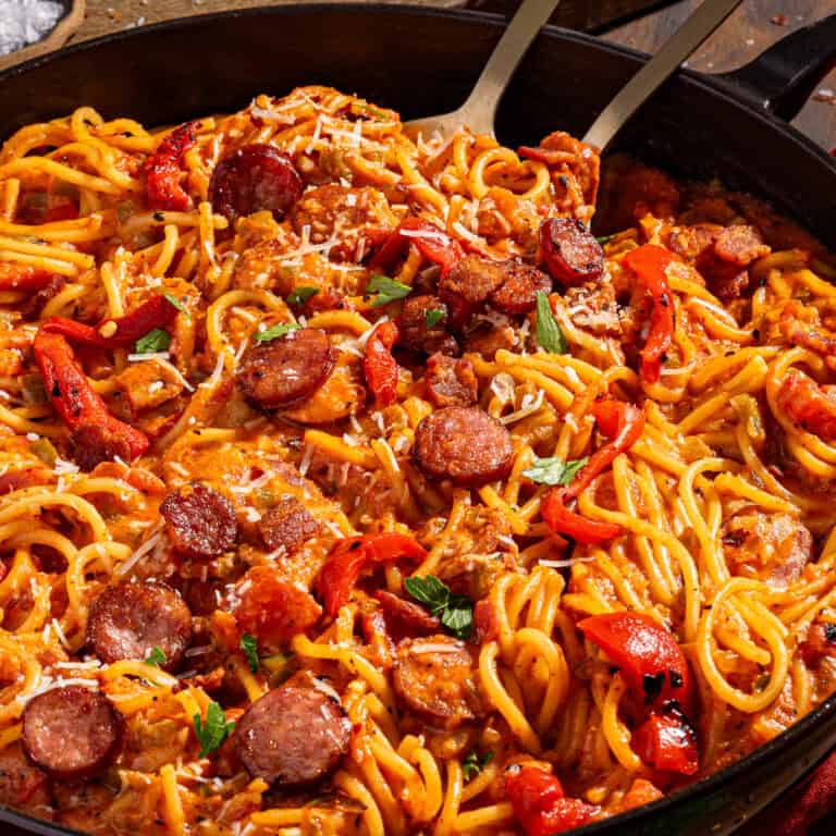 Skillet full of cajun spaghetti with andouille sausage.