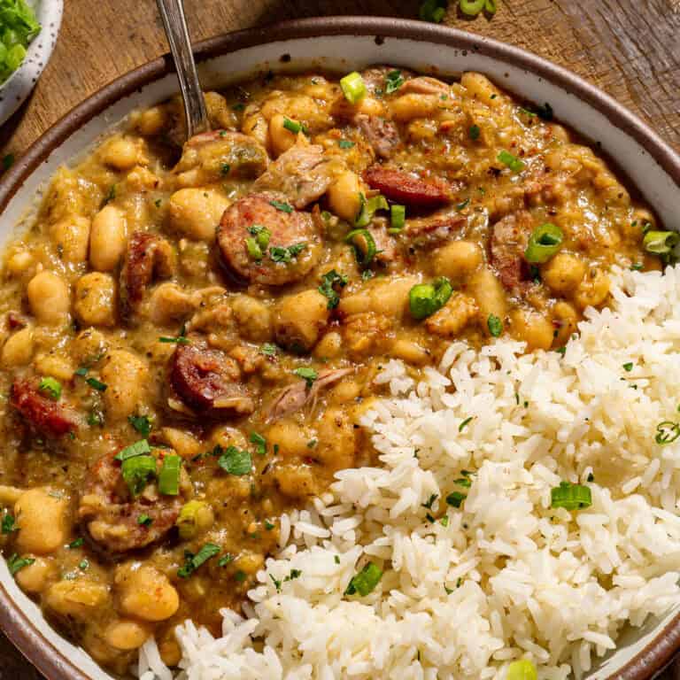 A bowl of white beans and rice with andouille and pork.
