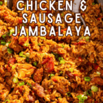 A large pot of chicken and sausage jambalaya with serving spoons.