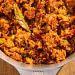 Chicken and sausage jambalaya in a Magnalite pot with a bay leaf.