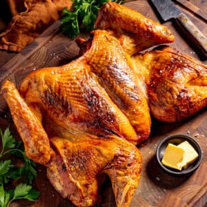 Cajun turkey with crispy skin on a cutting board.