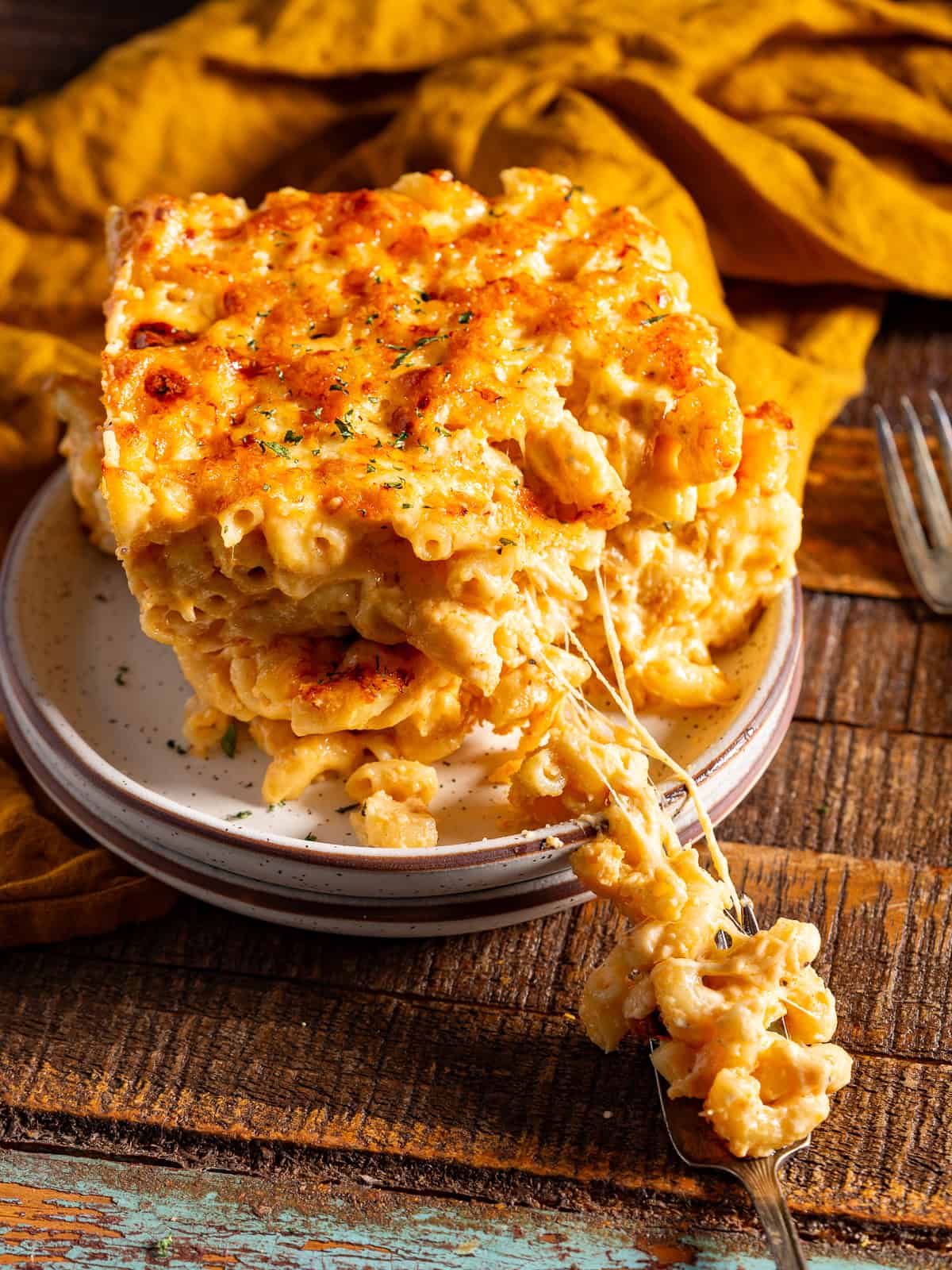 Cheese pull from a stack of baked mac and cheese.