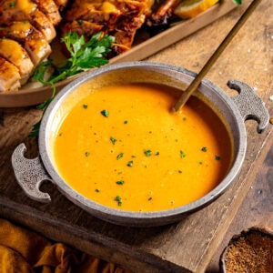 A bowl of cajun gravy with a spoon.