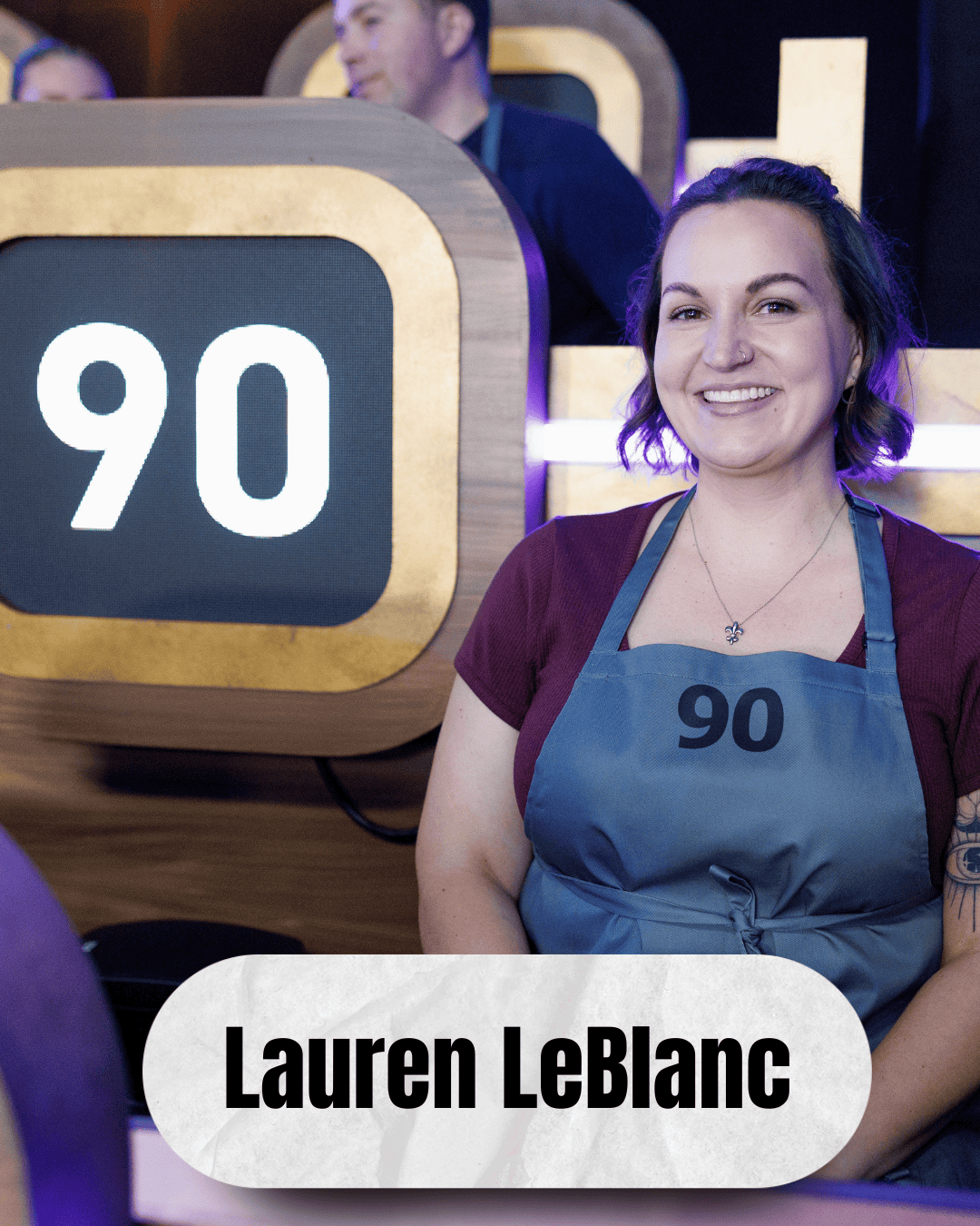 Lauren LeBlanc #90 sitting in the stands on Food Network's 100 Cooks.