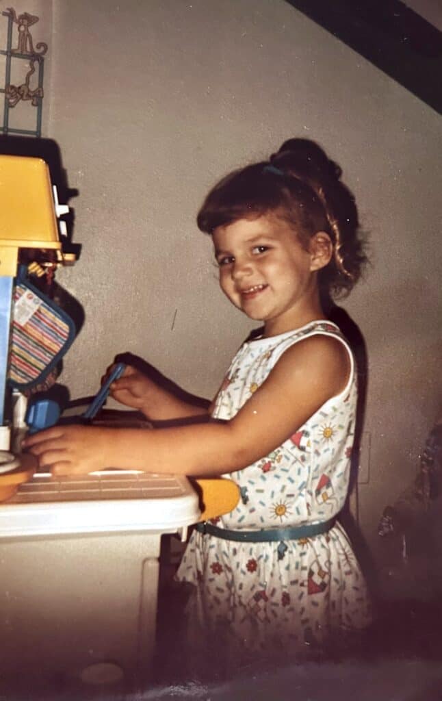 A child playing with her kitchen set.