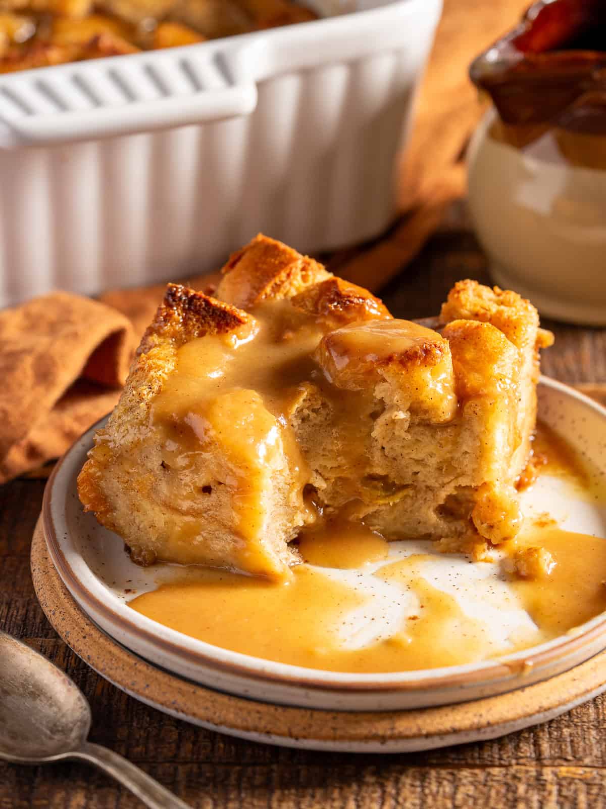 A slice of bread pudding with a bite taken out.